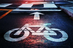 white bike symbol painted on road photographed at night